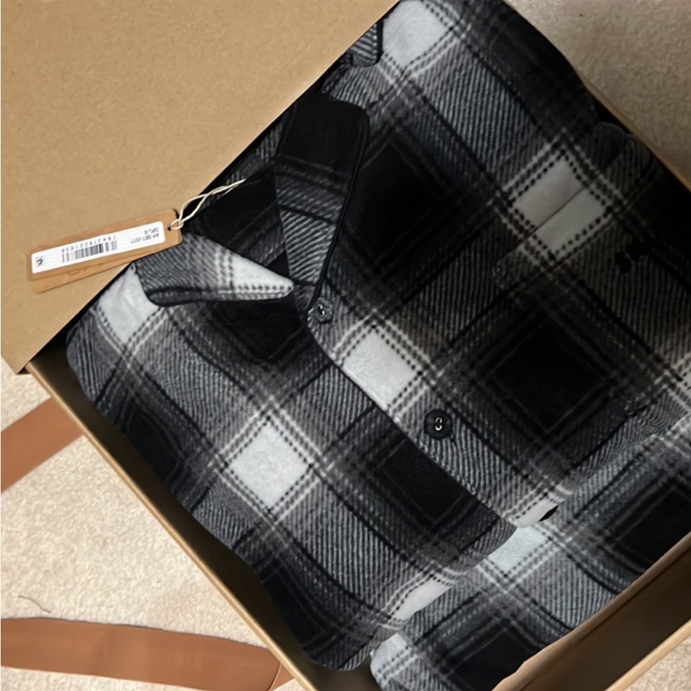 Brand new SKIMS flannel pajama size small, black, and white.